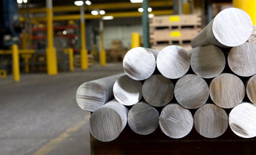 Bars of raw steel on a palette in a factory - Cannon Muskegon