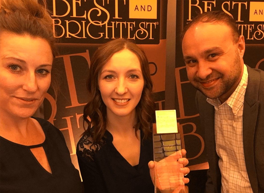 Andy, Kayla, and Sarah holding a Best and Brightest award