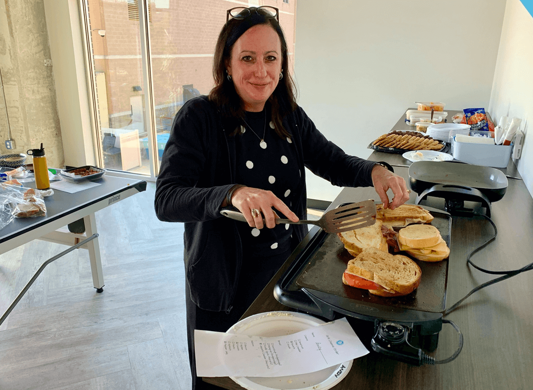Tracey Piasecki making grilled cheese fro the team at the Revel office