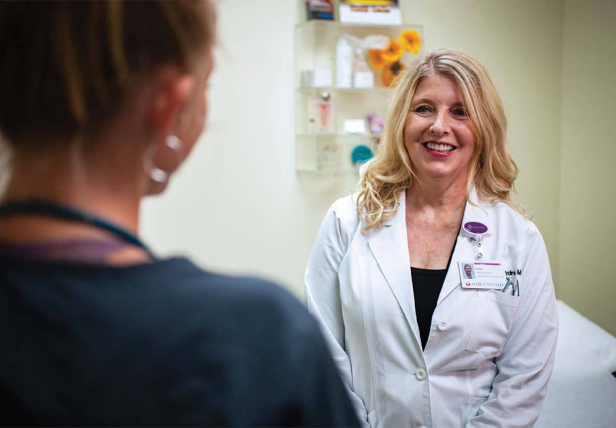 Trinity Health Alliance of Michigan Staff member in white scrubs