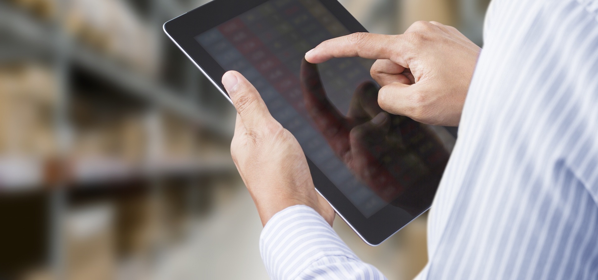 Male hands holding computer tablet