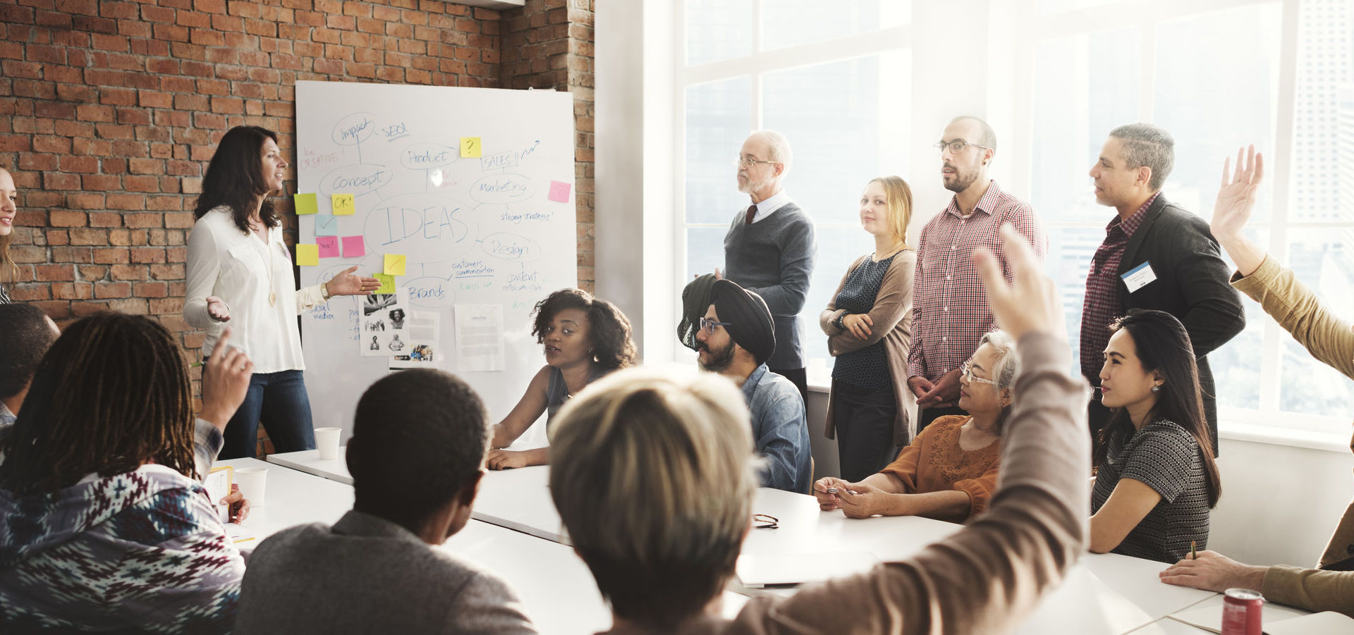 Employees meeting in conference room with whiteboard