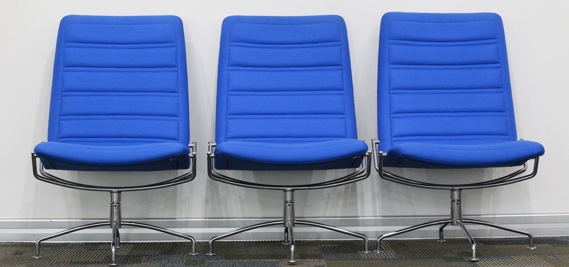 Three blue office chairs
