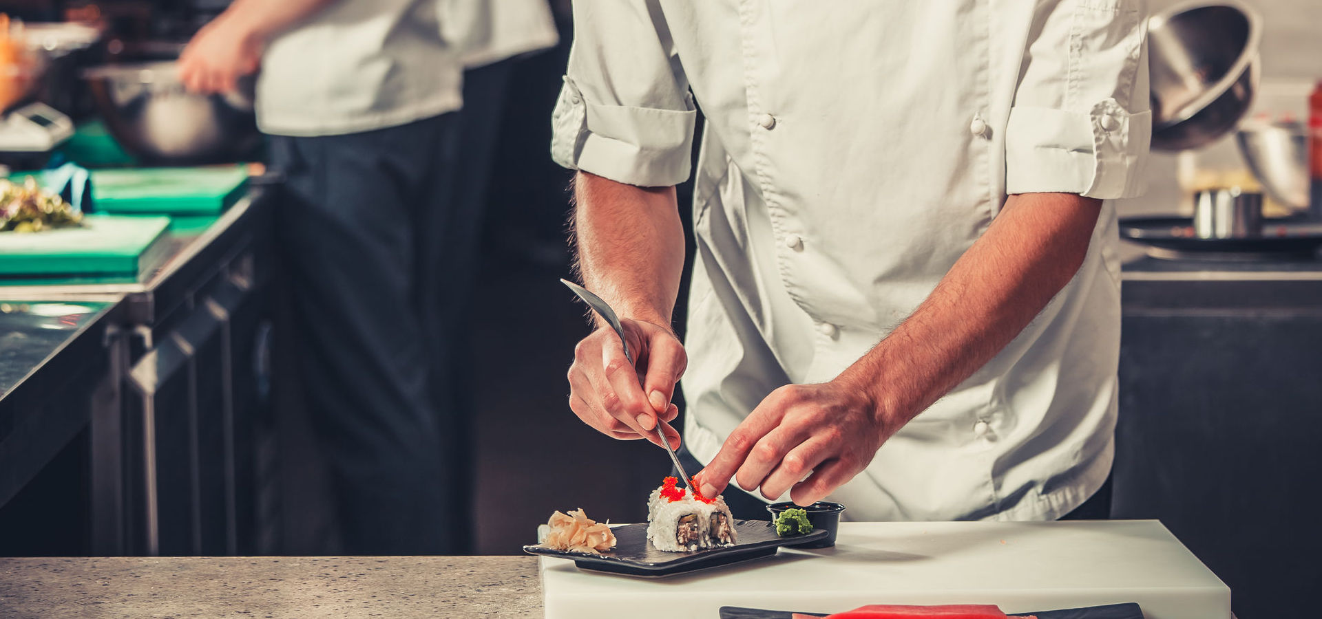 Male cooks preparing sushi in the restaurant kitchen
