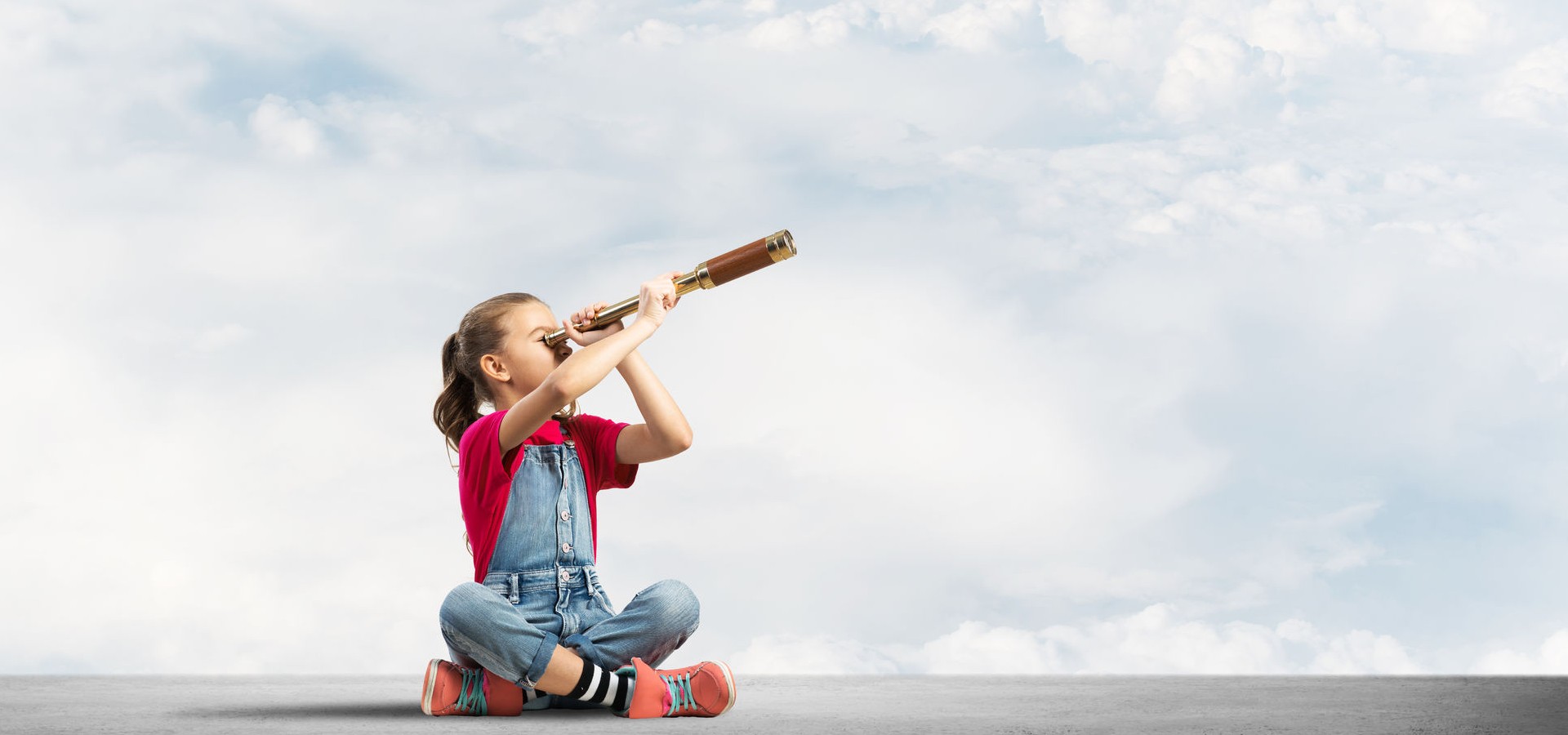 Girl looking through a telescope