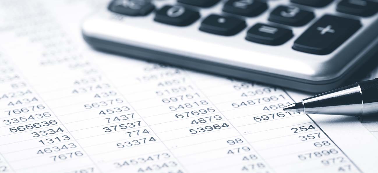 Pen resting on budget numbers on a piece of paper