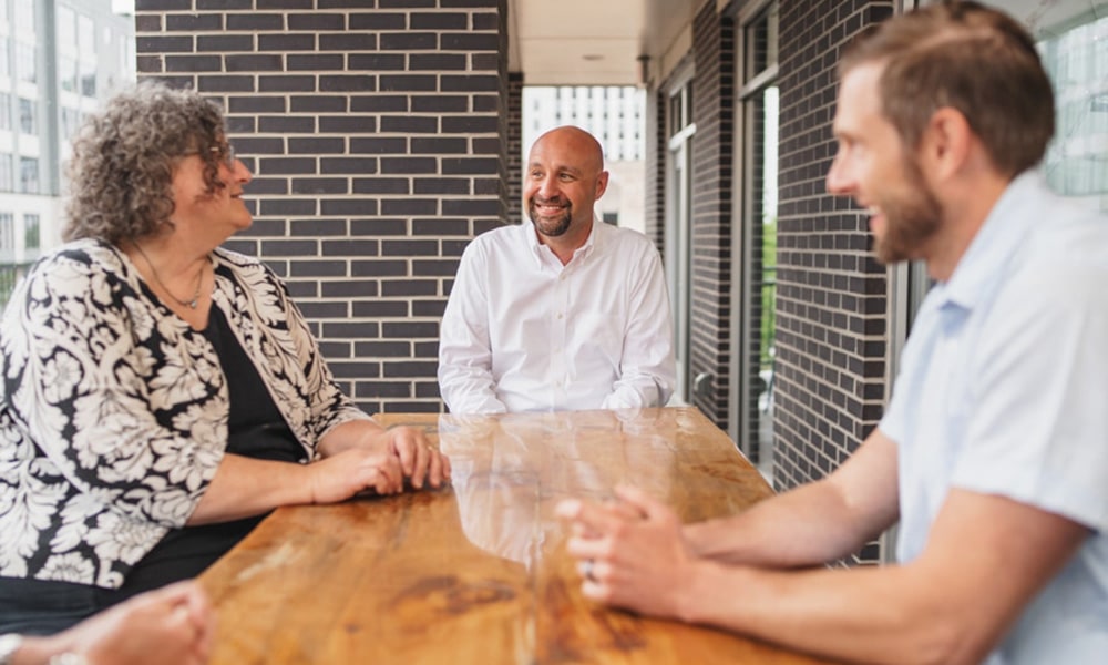 Tina Versaw, Andy Maciejewski and Jonathan Stepanski on the Revel balcony