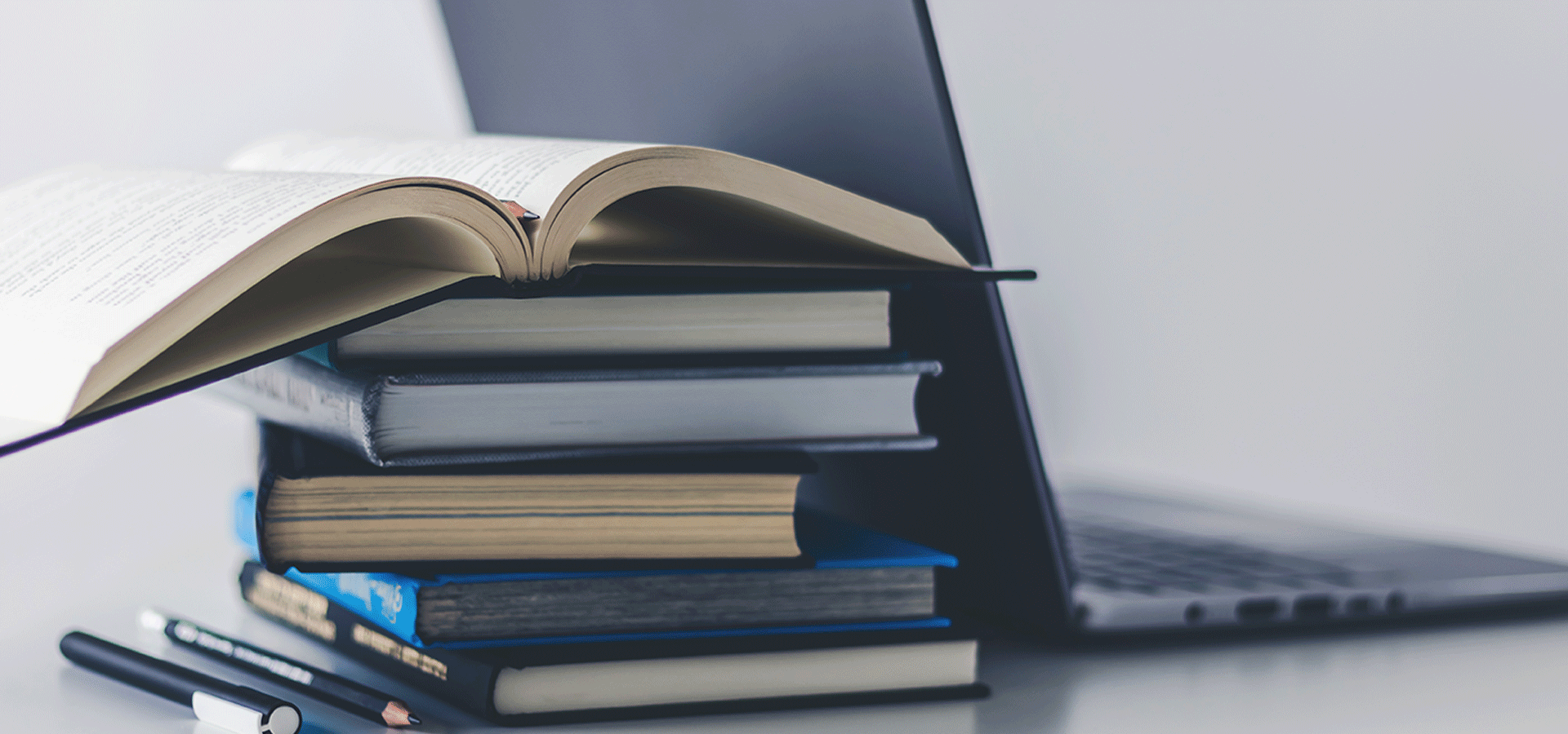 Stack of books and laptop computer