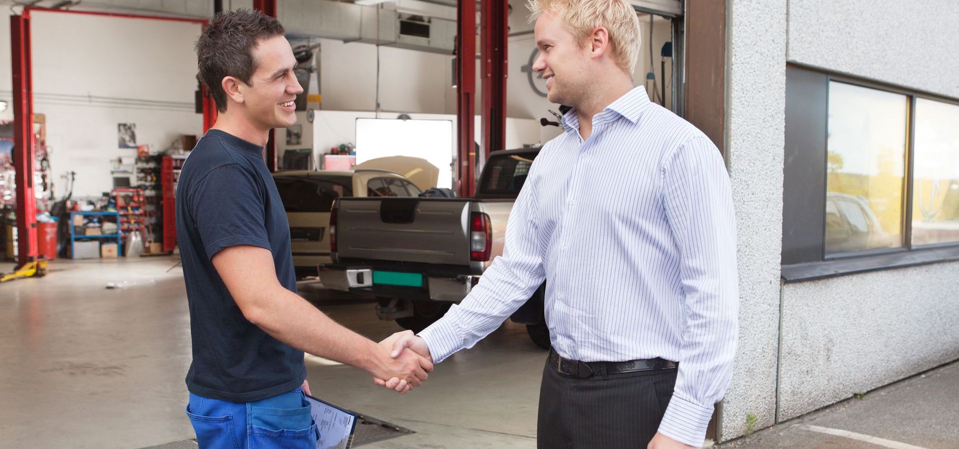 Mechanic shaking hands with client