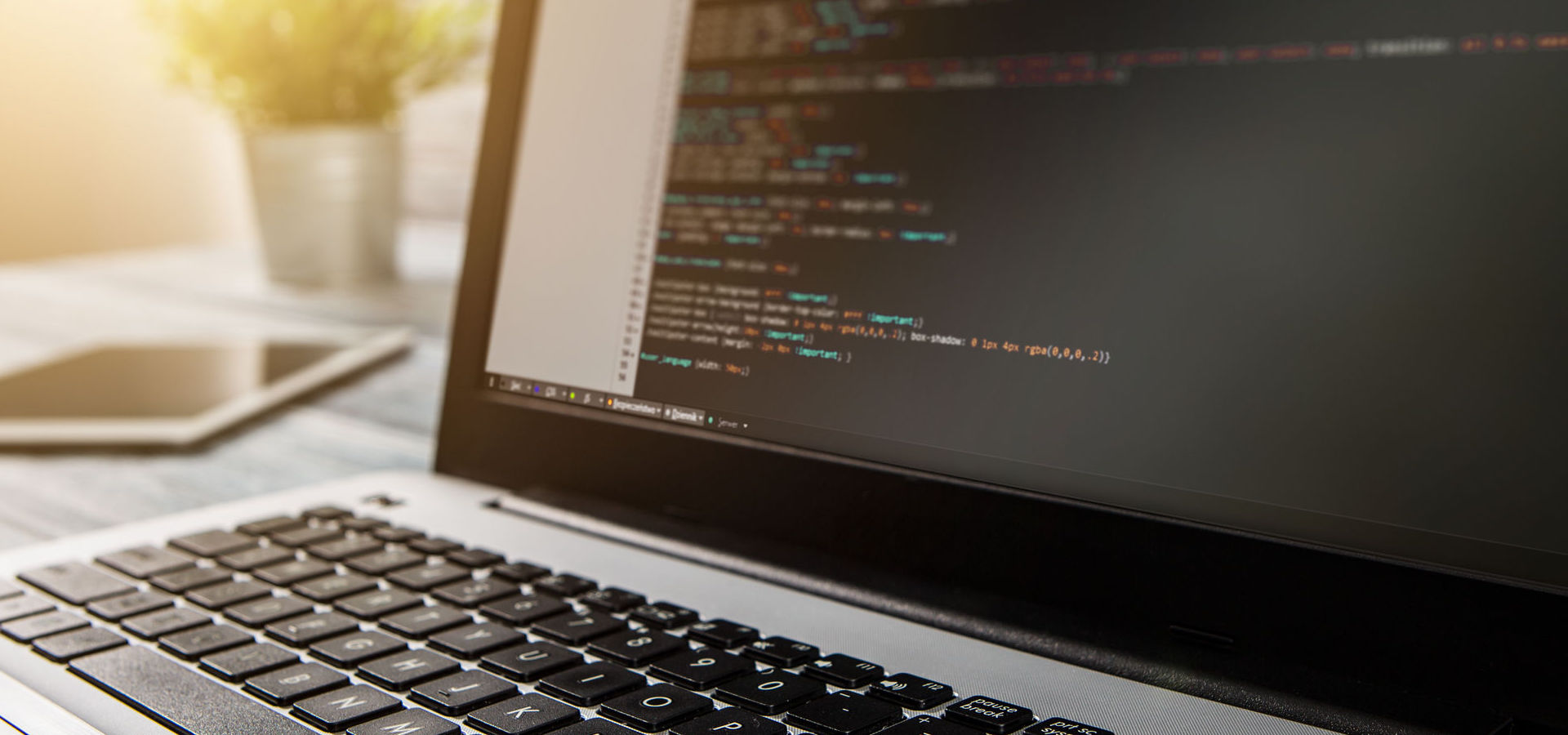 Laptop computer screen displaying web code