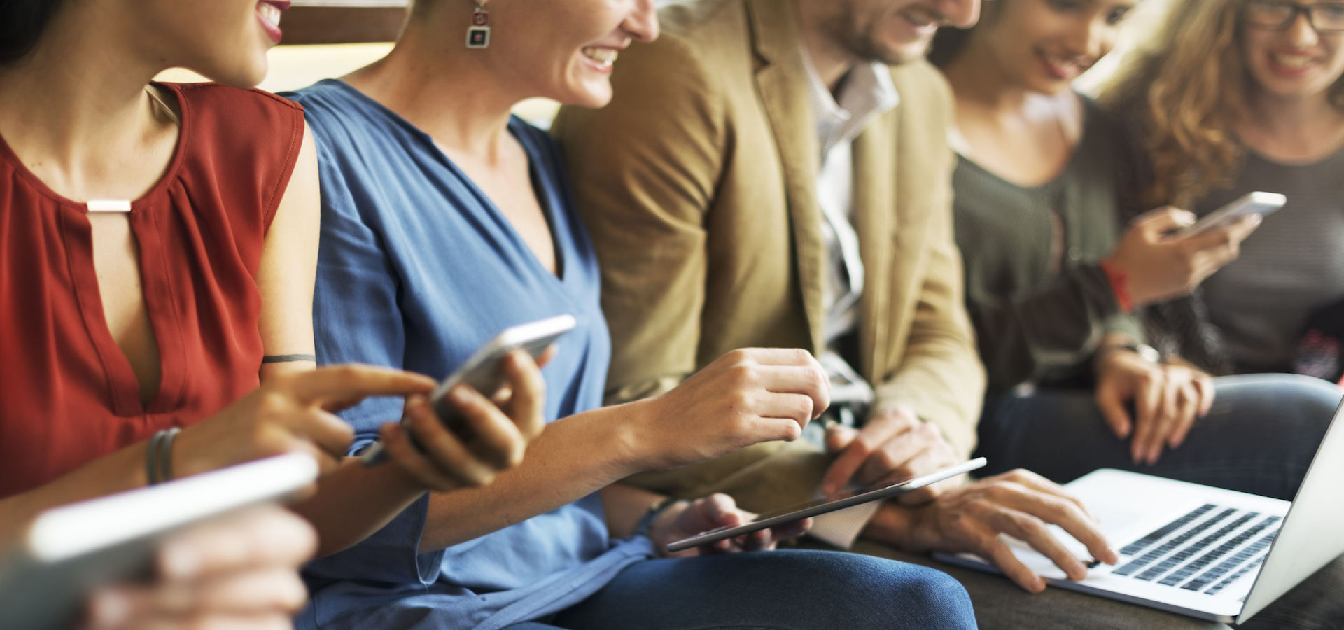 Diverse people on electronic devices